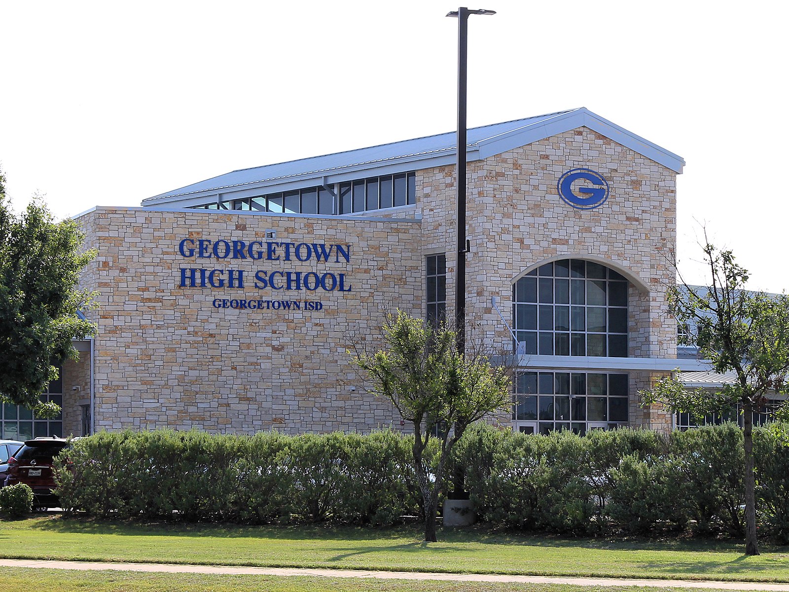 Families cheering at a Friday night football game